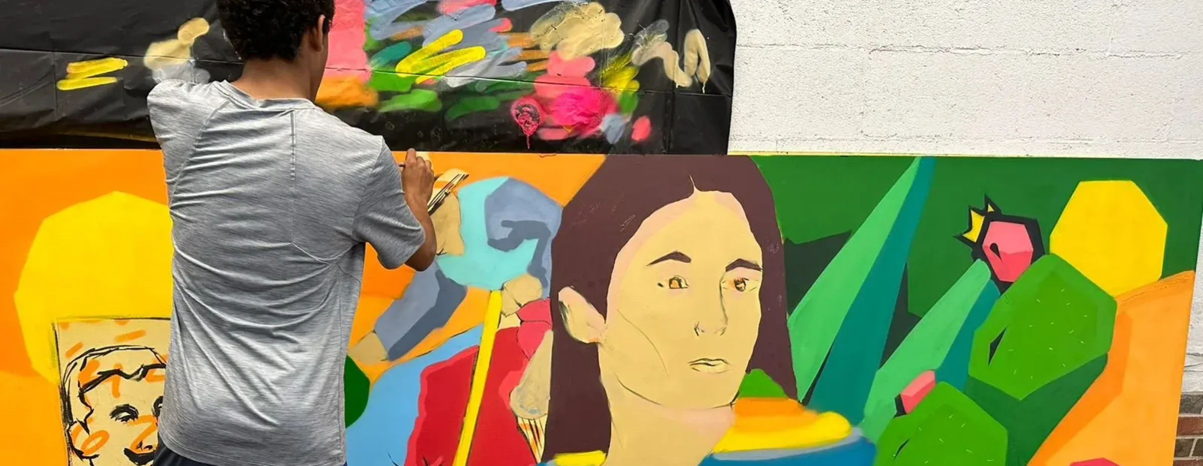 Students painting murals for the Heritage Corridor